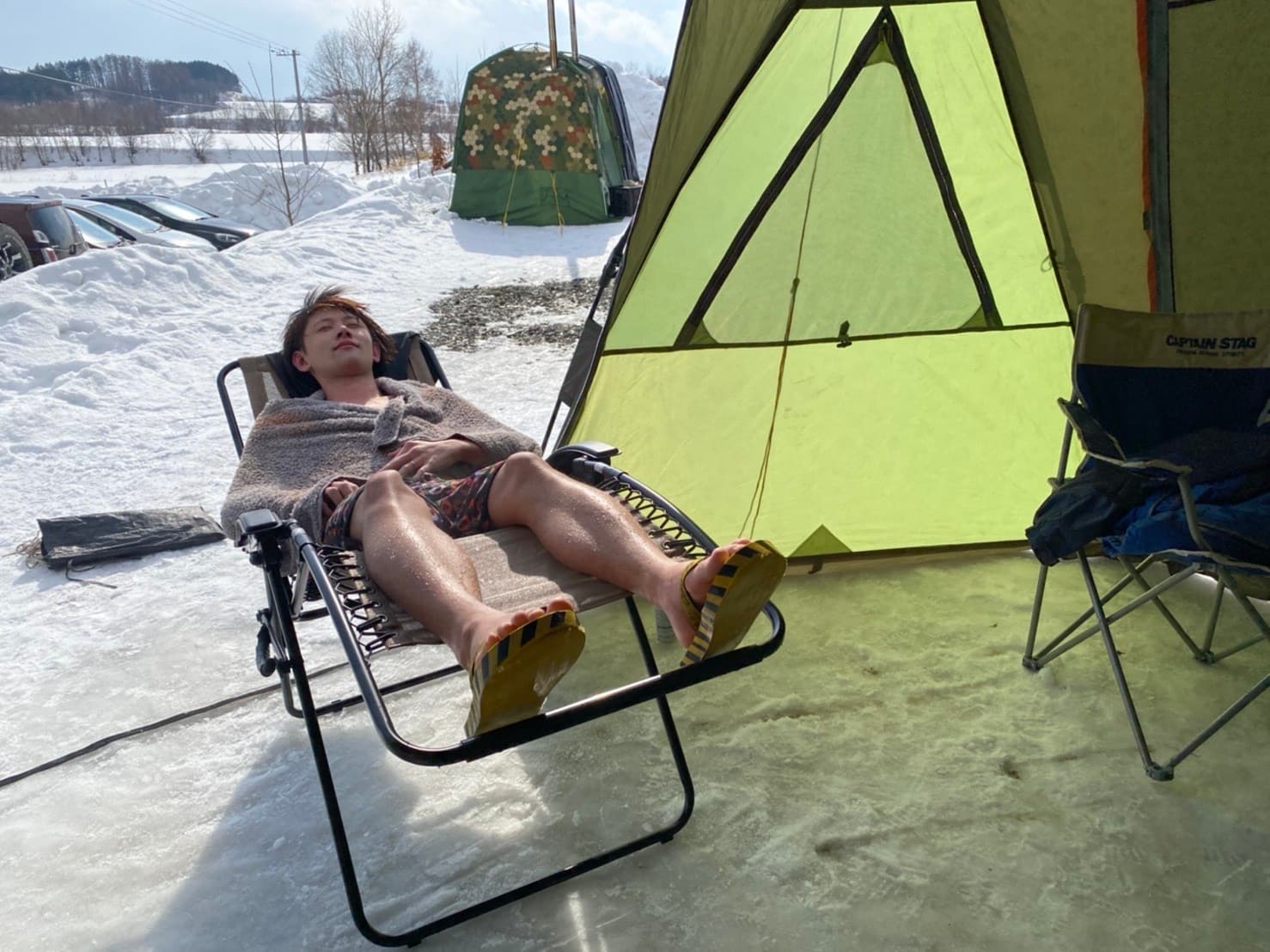 Nozomu Sato resting in the snow after a sauna, Hokkaido