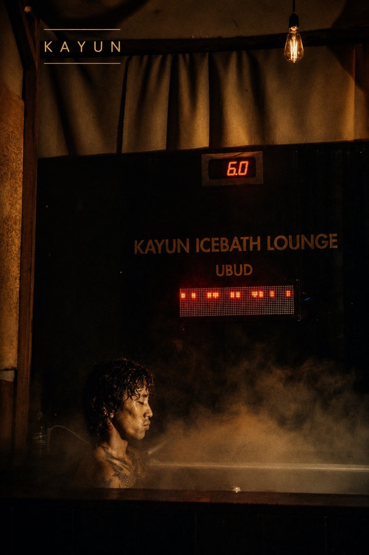 Cold plunge with steam rising, temperature display reading near 10°C