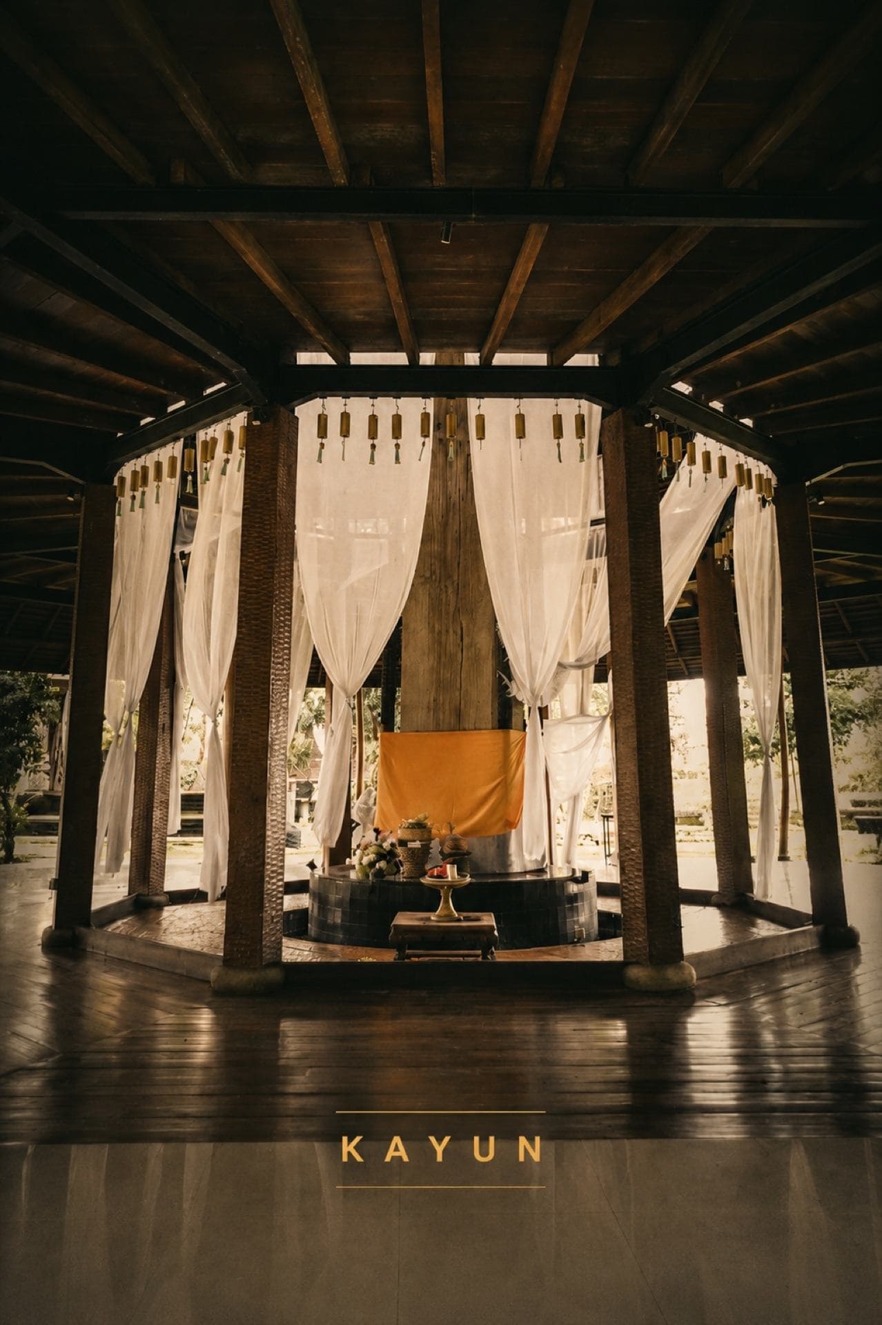 Open-air yoga shala with white curtains among the trees